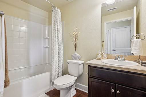 A white toilet sits next to a white sink in a bathroom.