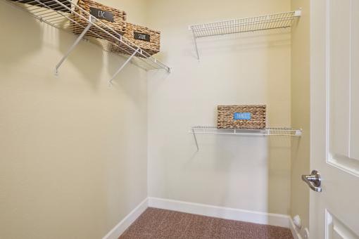 A hallway with two shelves and baskets on them.