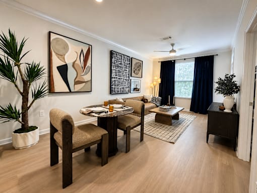 A living room with a dining table and chairs.