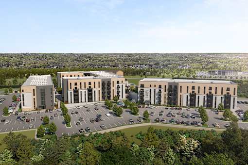 A large building complex with a parking lot in front.
