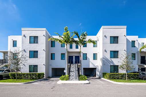 A white building with a blue sky in the background.