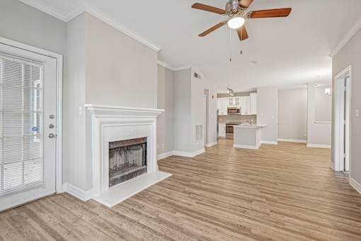 A room with a fireplace and a ceiling fan.