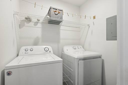 A white washing machine and dryer in a small laundry room.