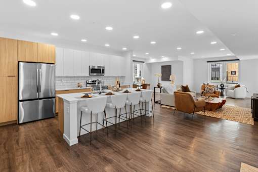 A modern kitchen with a dining area and a living room.