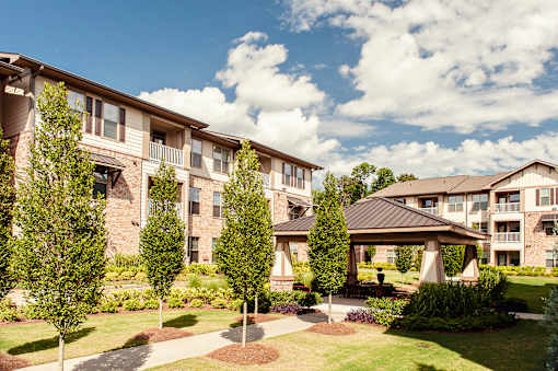 Apartment complex with a gazebo in the front yard.