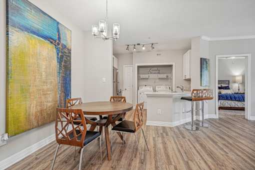 A dining room with a wooden table and chairs.