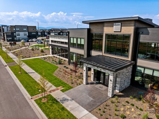 an aerial view of a building with a courtyard and grass
