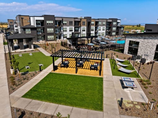 an aerial view of an apartment complex with a picnic area and lawn