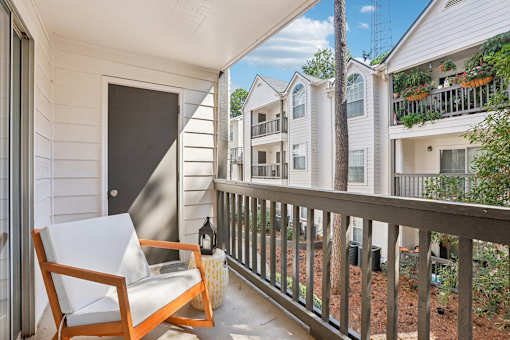 A balcony with a chair and table.