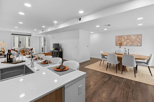 A modern kitchen with a dining table and chairs.