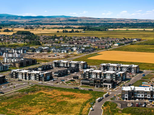 an aerial view of a city with buildings and a field
