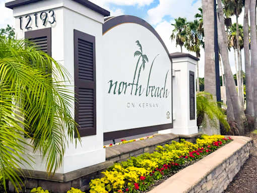 A white building with a sign that says North Beach on it.
