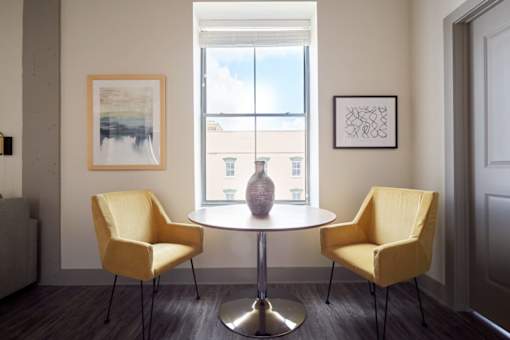 A room with a table and two chairs.