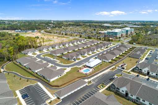 an aerial view of a group of houses in a parking lot