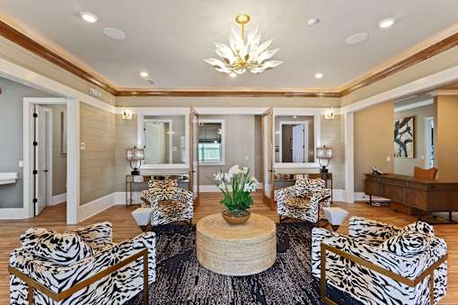 a living room with zebra print chairs and a table