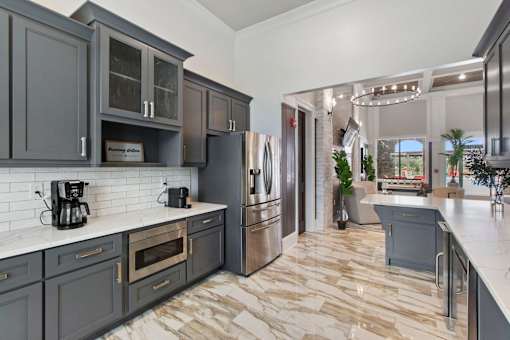 the lobby of a luxury hotel with marble floors and grey walls