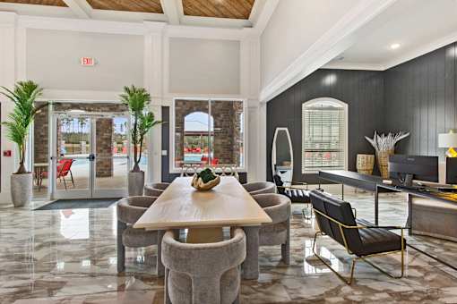 a living room with a table and chairs
