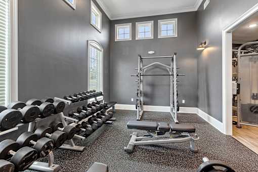 a gym with dumbbells and weights on the floor