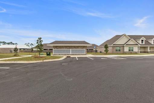 an empty parking lot in front of a house