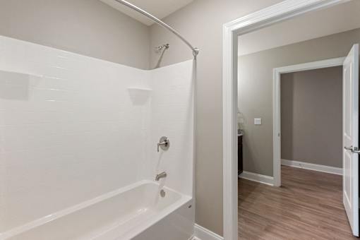 the preserve at ballantyne commons apartment bathroom with tub and walk in shower