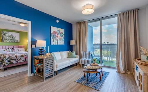 A living room with a blue wall and a white couch.