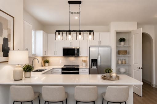 A modern kitchen with a large island and four chairs.