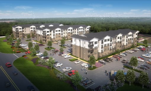 an aerial view of an apartment complex with a parking lot