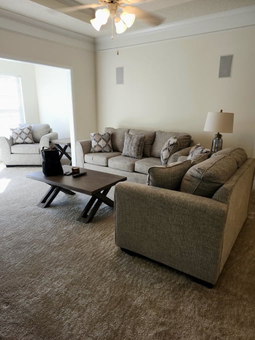 a living room with couches and a coffee table