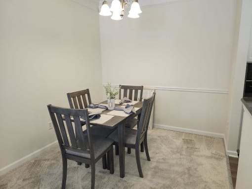 a dining room with a table and chairs