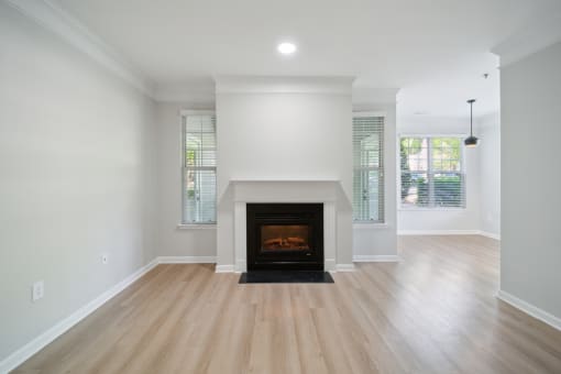 a living room with a fireplace and wooden floors