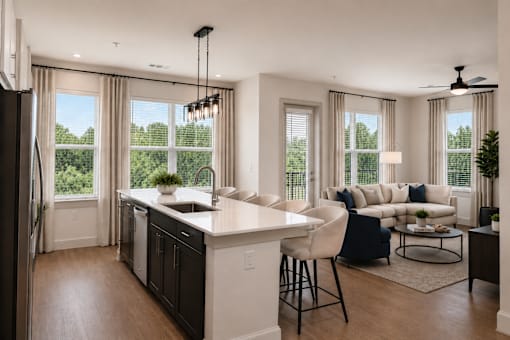A modern kitchen with a large island and a dining area with a view.
