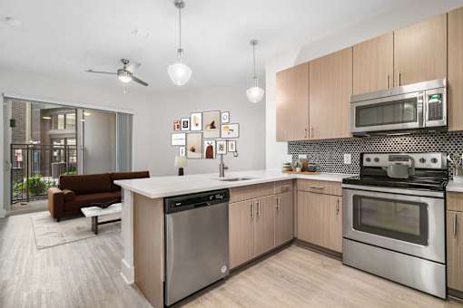 A modern kitchen with a dining area and a balcony.