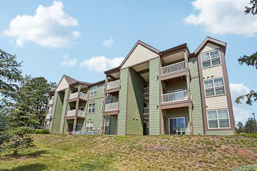 A large apartment building with balconies and multiple stories.