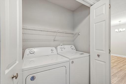A white laundry room with a washer and dryer.