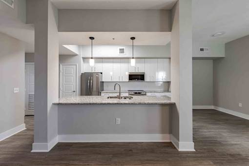 A kitchen with a sink and a refrigerator.