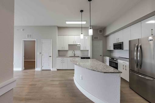 A modern kitchen with stainless steel appliances and a central island.