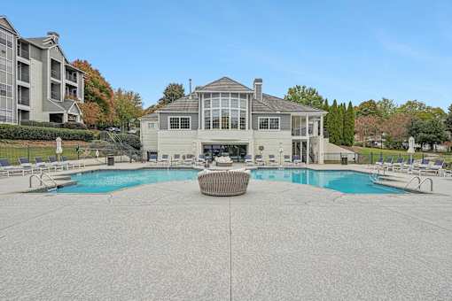 A large house with a pool in front.