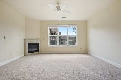 A room with a fireplace and a ceiling fan.