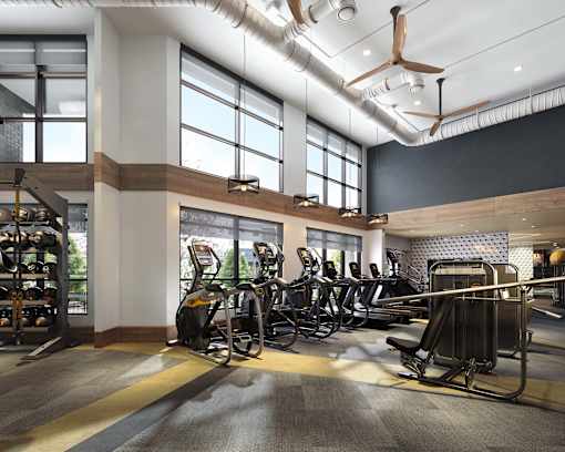 a gym with cardio machines and weights in a lobby