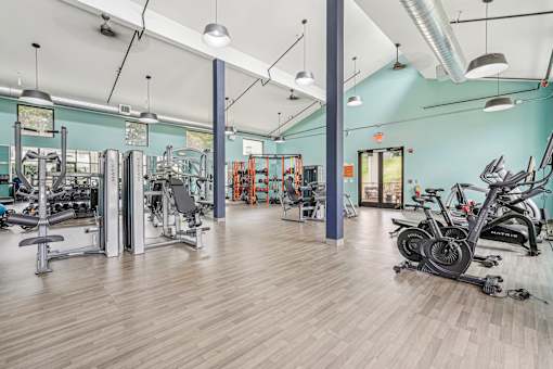 A gym with a variety of exercise equipment.