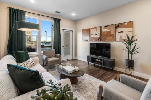 a living room with a couch and chairs and a television