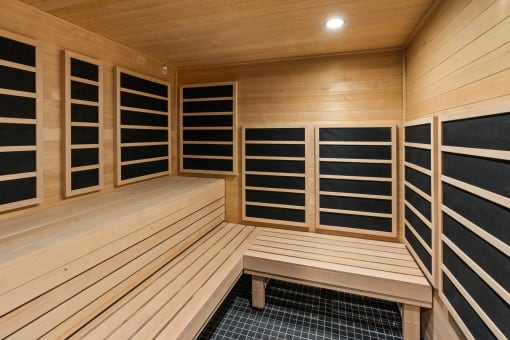 a sauna with a bench and a wall of closets