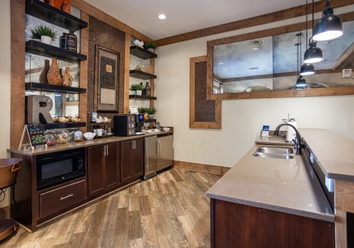 a large kitchen with stainless steel appliances and a sink