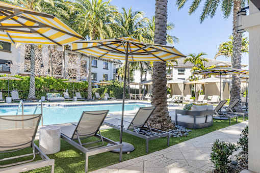 A poolside area with lounge chairs and umbrellas.