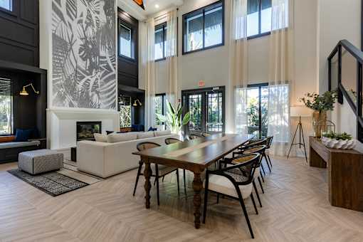 A modern living room with a fireplace and a dining table.