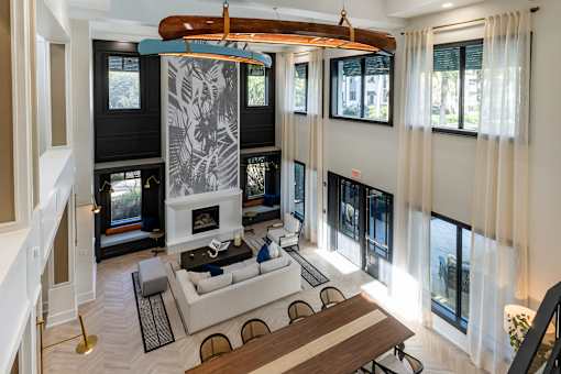 A modern living room with a fireplace and a dining table.