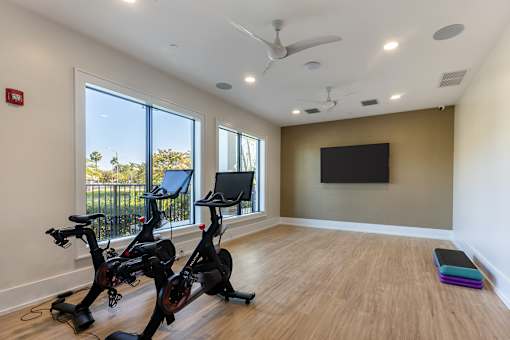 A room with exercise equipment and a flat screen TV.