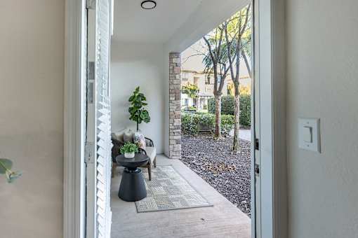 A view of a patio through an open door.