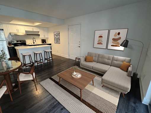 A modern living room with a grey couch and a wooden coffee table.
