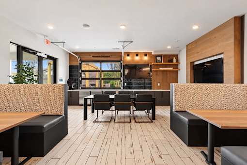 A modern dining area with wooden floors and furniture.